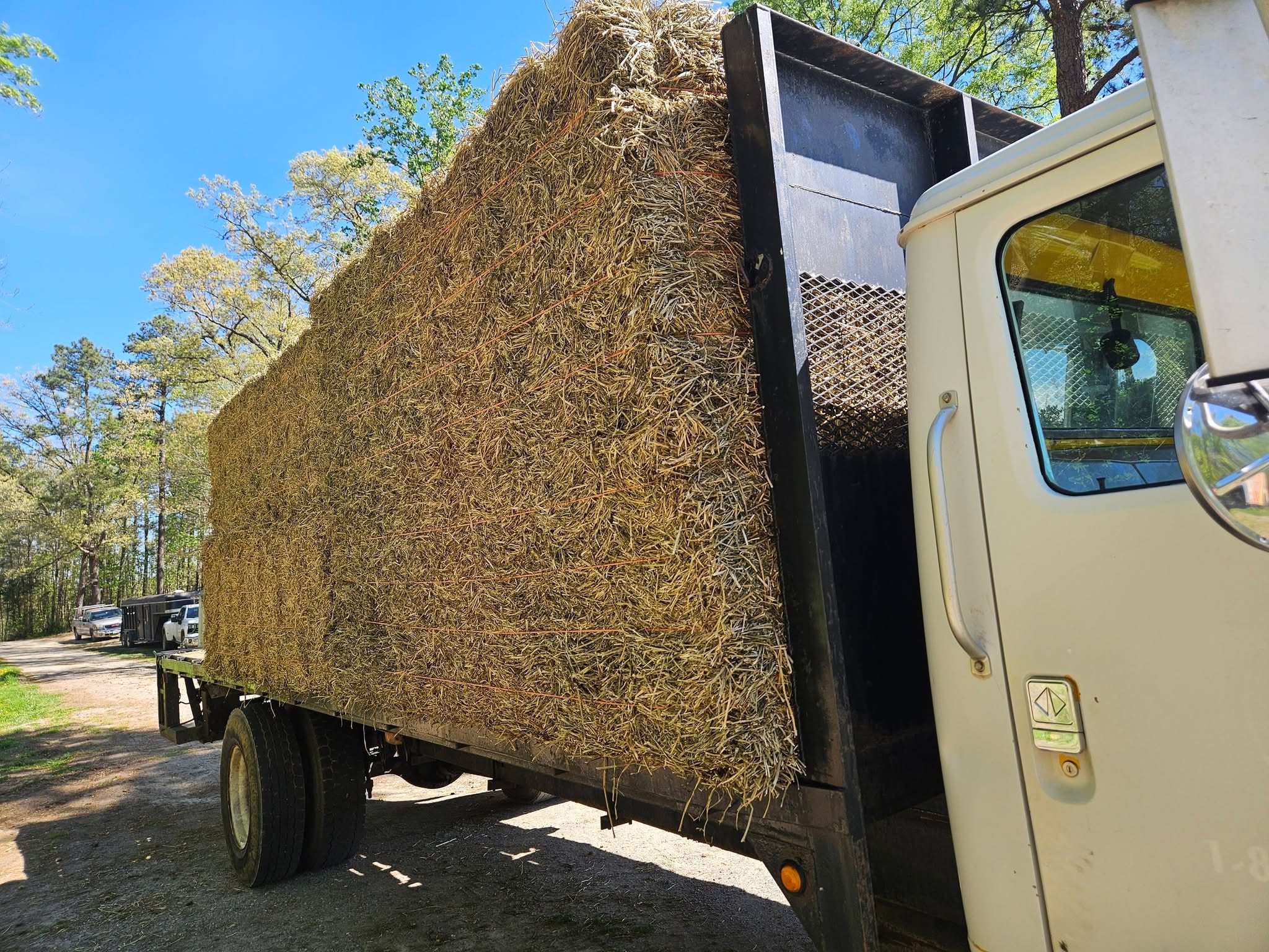 Truck carrying large rectangular hay bale