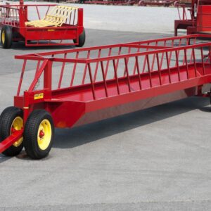Red mobile livestock feeder trailer with yellow wheels