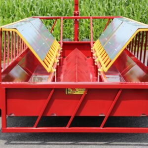 Red farm feed wagon with cornfield backdrop